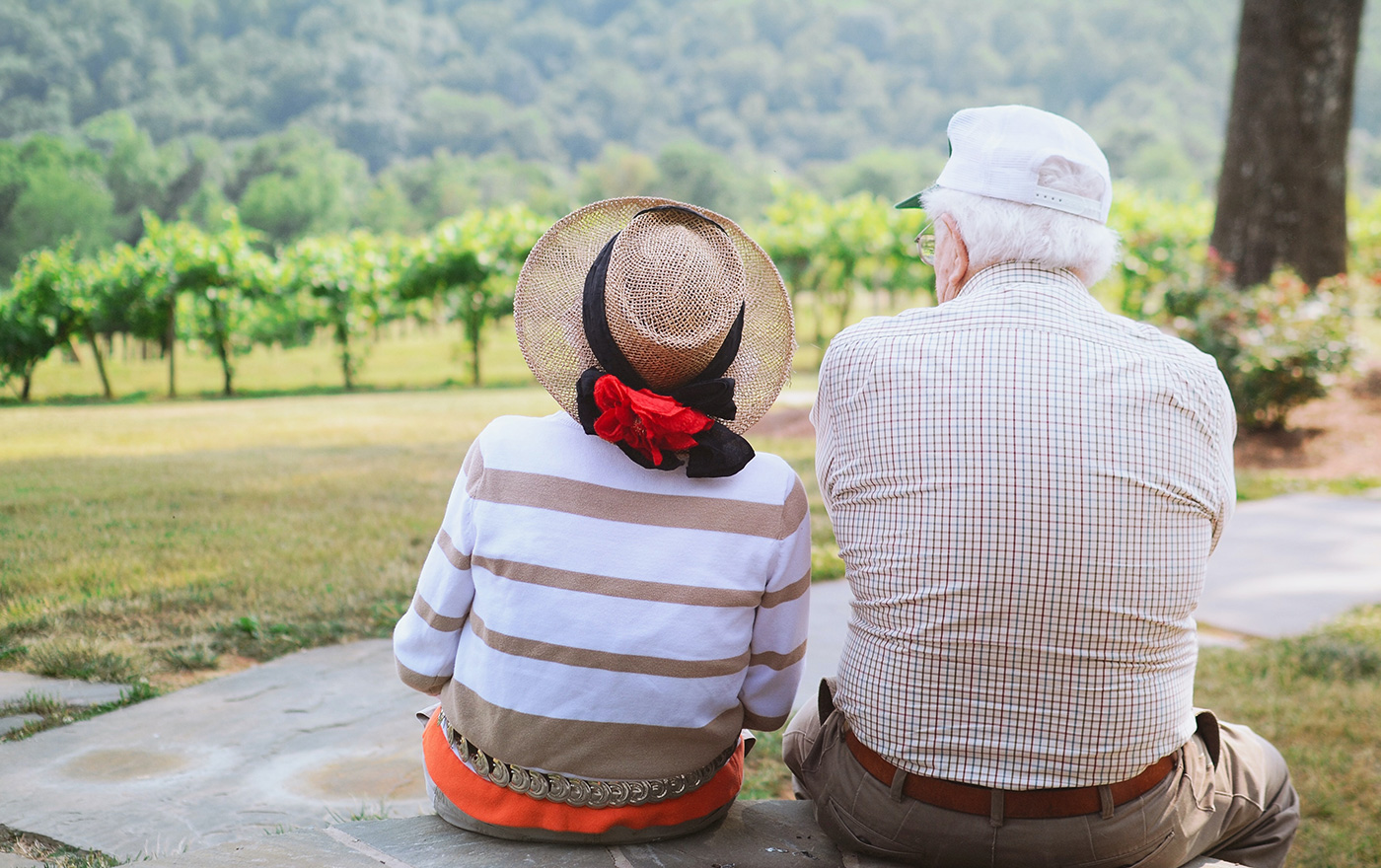 Aged care couple overlooking beautiful vineyard