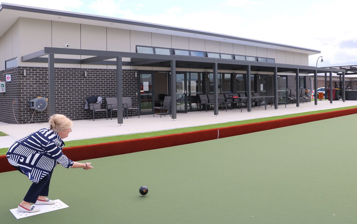 Aged care resident playing lawn bowls