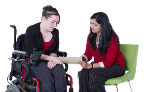 A support worker helping to explain something to a woman